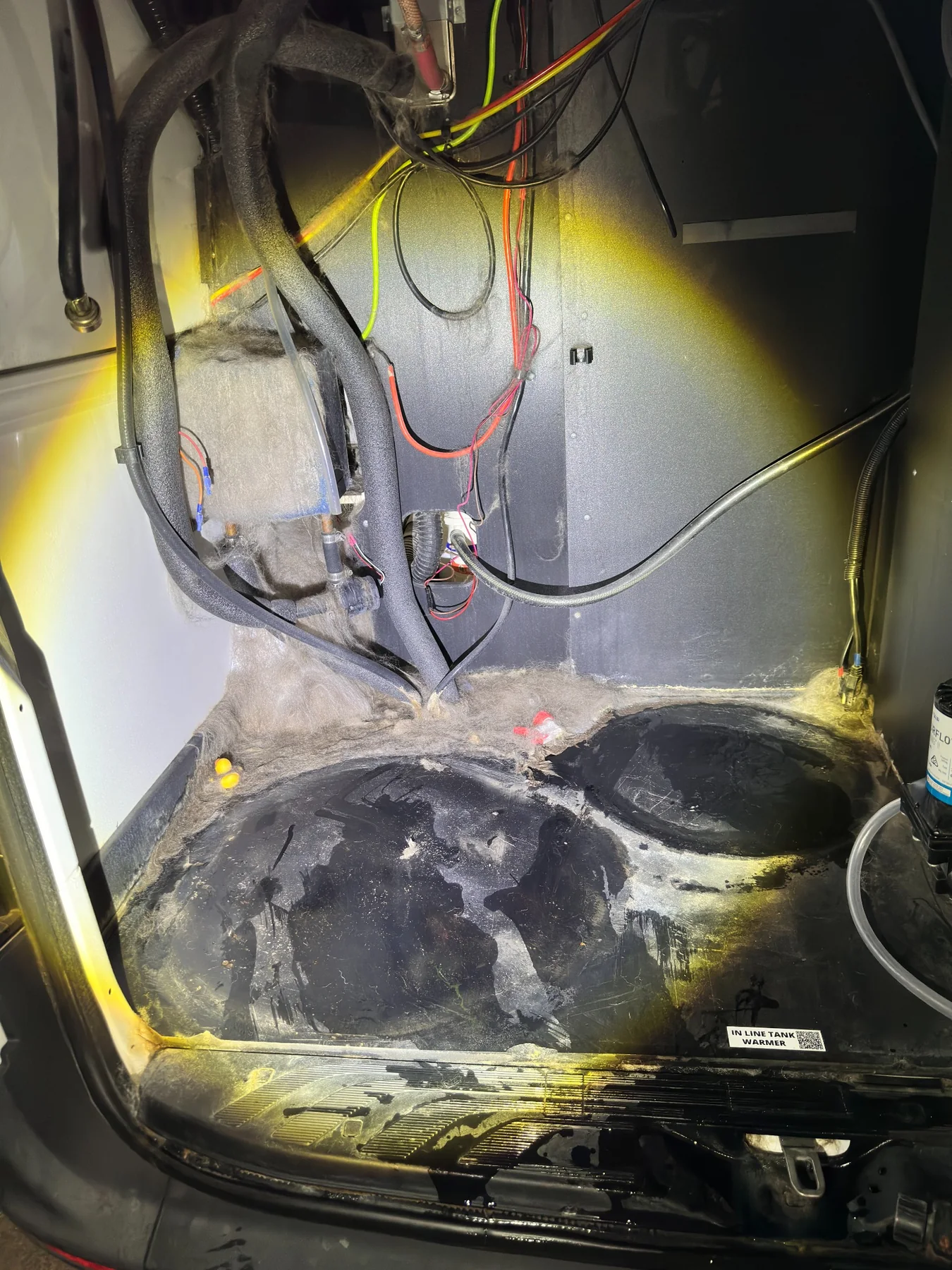 Rear utility area of mobile pet styling van before deep cleaning