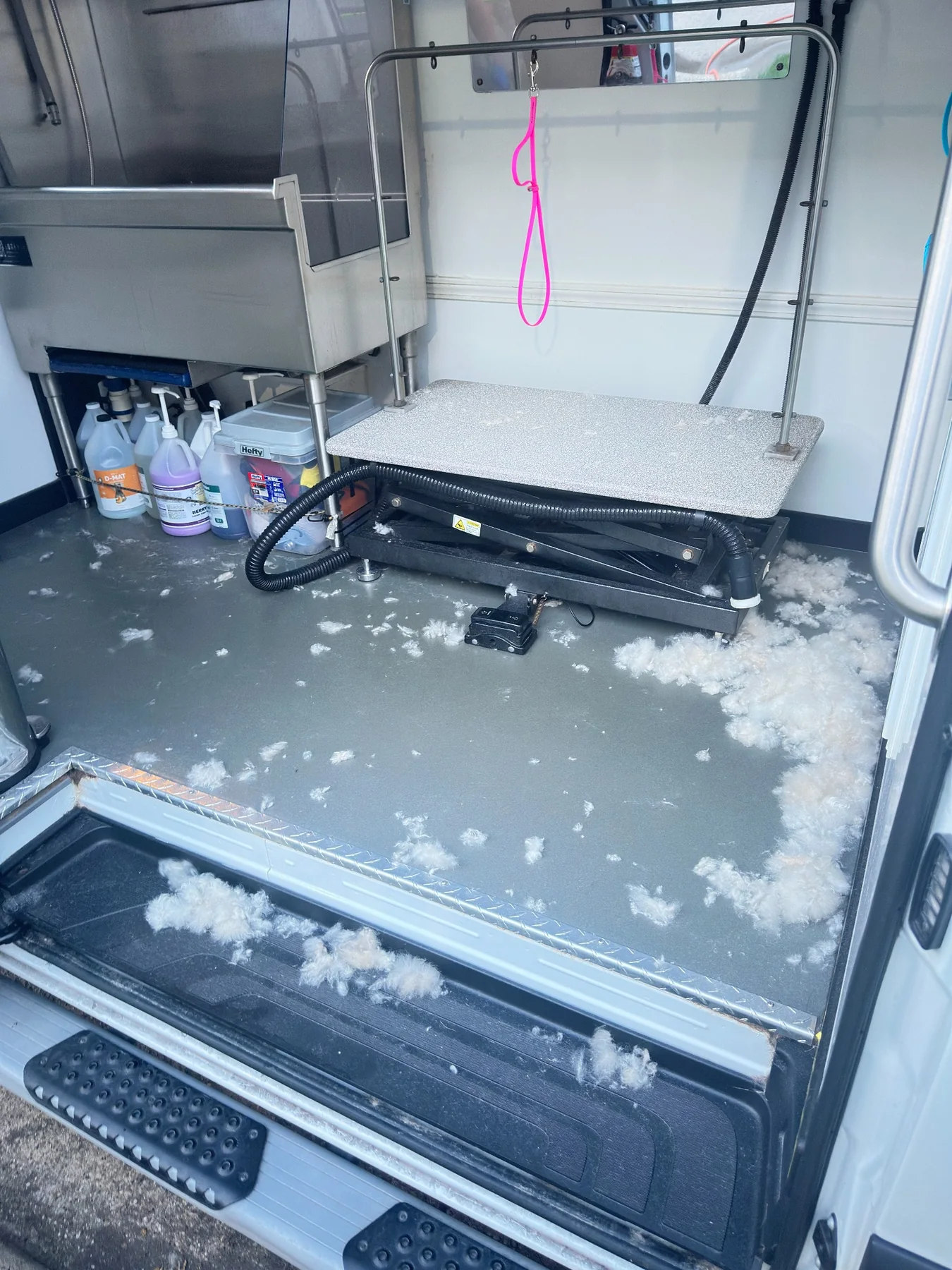 Mobile pet styling van interior with hair and debris before cleaning